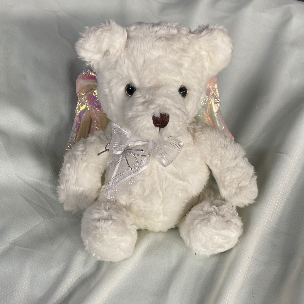 Adorable fluffy white bear with iridescent wings